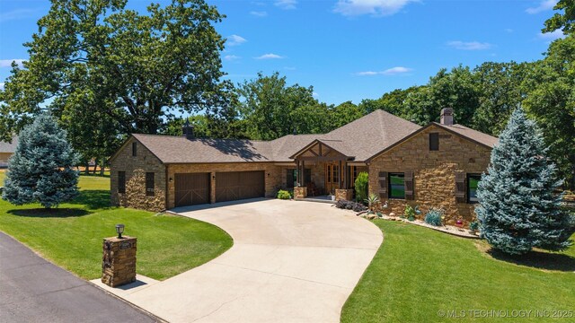 33268 Cardinal Dr, Afton, OK 74331 - view of front of home featuring stone siding, a garage, concrete driveway, and a front yard