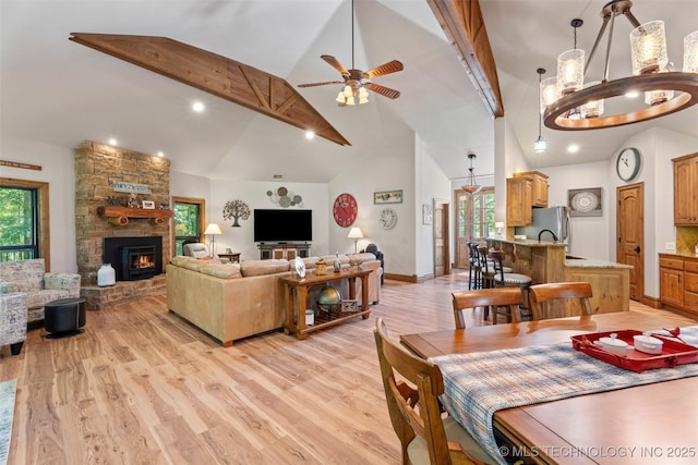 33268 Cardinal Dr, Afton, OK 74331 - dining space featuring light wood-style floors, healthy amount of natural light, a ceiling fan, high vaulted ceiling, and a large fireplace