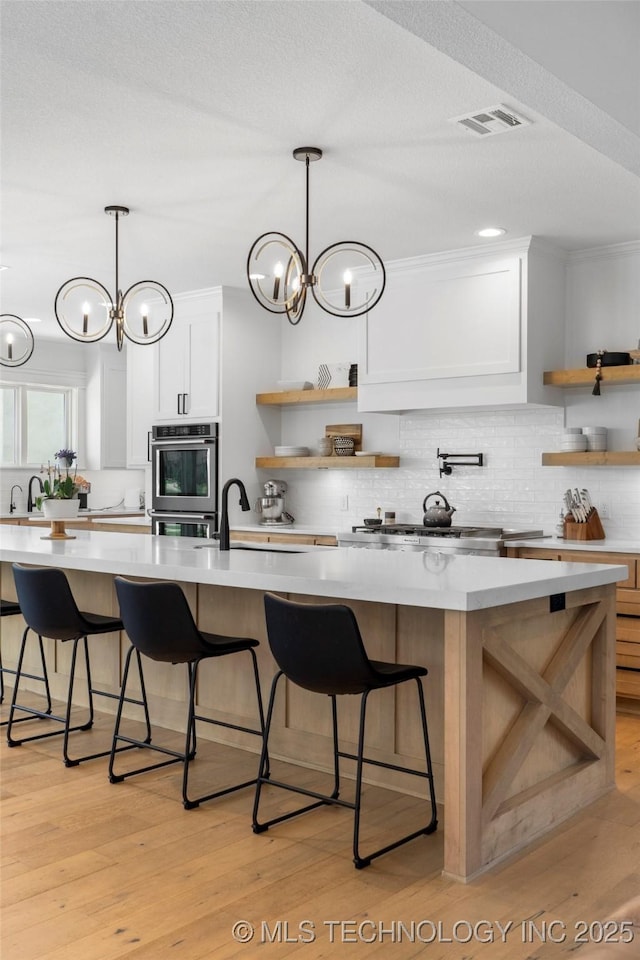 7408 E College St, Broken Arrow, OK 74014 - kitchen featuring open shelves, light countertops, a sink, and backsplash