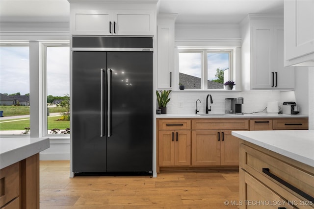7408 E College St, Broken Arrow, OK 74014 - kitchen featuring high quality fridge, a sink, light countertops, plenty of natural light, and crown molding