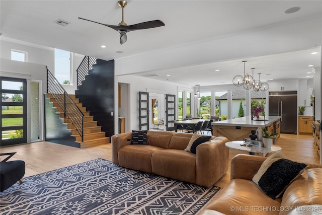 7408 E College St, Broken Arrow, OK 74014 - living area with light wood-style flooring, stairs, a chandelier, recessed lighting, and a ceiling fan
