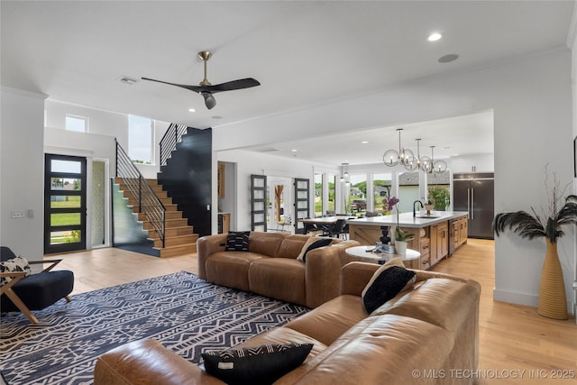 7408 E College St, Broken Arrow, OK 74014 - living room with light wood finished floors, stairs, a ceiling fan, and recessed lighting