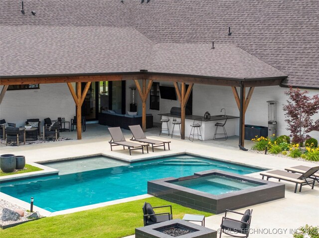 7408 E College St, Broken Arrow, OK 74014 - view of pool featuring exterior bar, a patio area, an outdoor living space with a fire pit, a pool with connected hot tub, and area for grilling