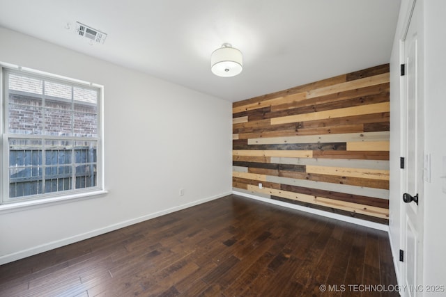 12523 S Cedar Pl, Jenks, OK 74037 - unfurnished room with wood walls and dark wood-type flooring