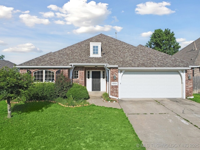 12523 S Cedar Pl, Jenks, OK 74037 - view of front facade with brick siding, concrete driveway, a front yard, an attached garage, and roof with shingles