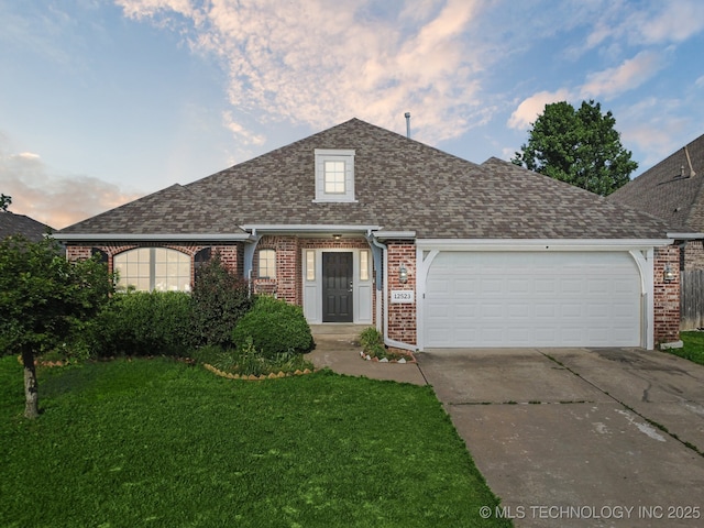 12523 S Cedar Pl, Jenks, OK 74037 - view of front of property featuring brick siding, driveway, a yard, a garage, and roof with shingles