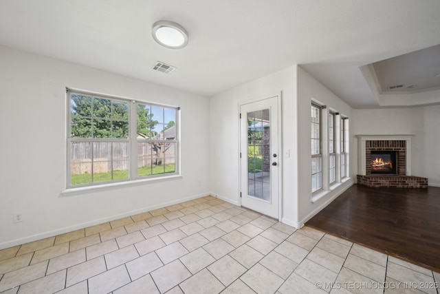 12523 S Cedar Pl, Jenks, OK 74037 - foyer featuring a fireplace and light tile patterned floors