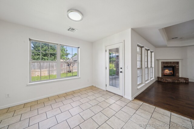 12523 S Cedar Pl, Jenks, OK 74037 - foyer featuring a fireplace and light tile patterned floors