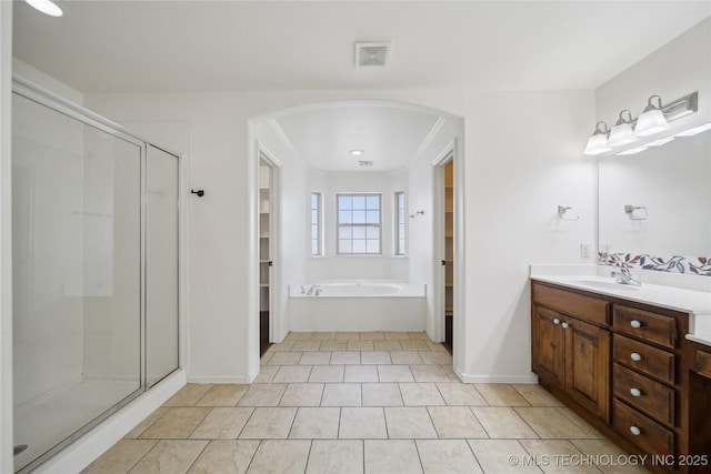 12523 S Cedar Pl, Jenks, OK 74037 - bathroom featuring vanity, a shower stall, a spacious closet, and a bath
