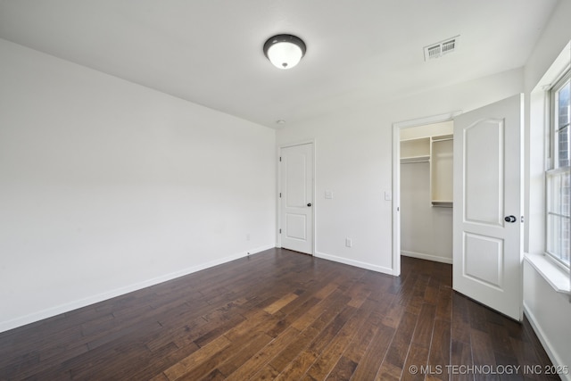 12523 S Cedar Pl, Jenks, OK 74037 - unfurnished bedroom with dark wood-style floors, a walk in closet, and a closet