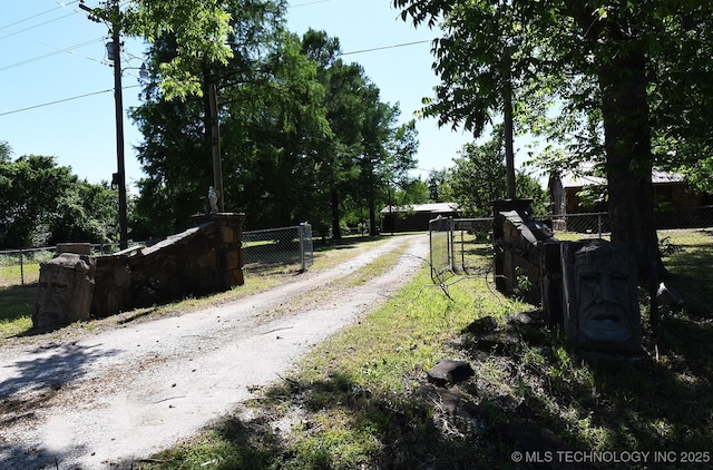 17079 S 125th St, Webbers Falls, OK 74470 - view of dirt / gravel driveway featuring a gated entry and a gate