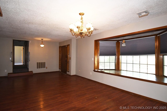17079 S 125th St, Webbers Falls, OK 74470 - spare room featuring a textured ceiling, a chandelier, wood finished floors, and baseboards