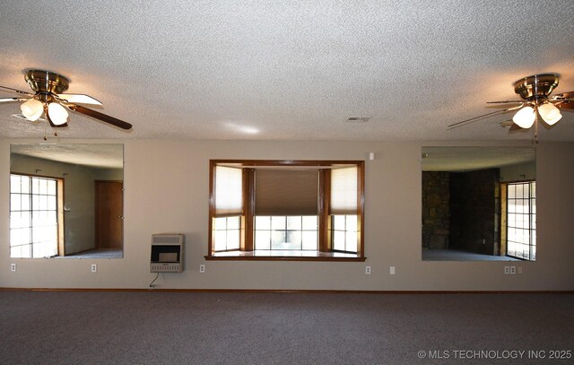 17079 S 125th St, Webbers Falls, OK 74470 - unfurnished living room featuring a ceiling fan, heating unit, a textured ceiling, carpet floors, and baseboards