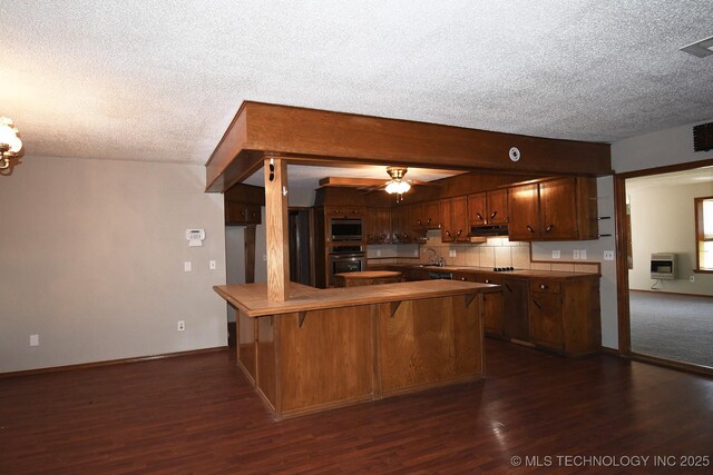 17079 S 125th St, Webbers Falls, OK 74470 - kitchen with a textured ceiling, oven, heating unit, a peninsula, and dark wood-style floors