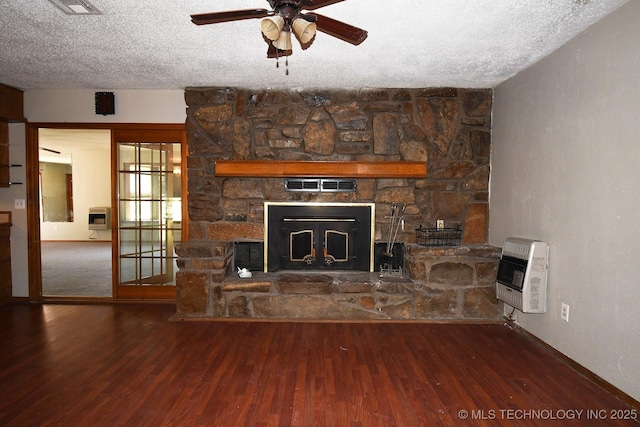 17079 S 125th St, Webbers Falls, OK 74470 - unfurnished living room featuring heating unit, wood finished floors, a ceiling fan, a textured ceiling, and a stone fireplace