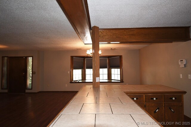 17079 S 125th St, Webbers Falls, OK 74470 - kitchen featuring tile counters, a textured ceiling, open floor plan, and wood finished floors