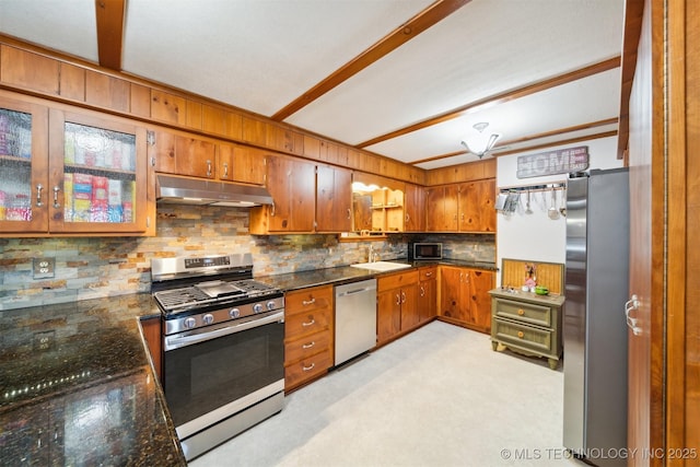 16881 S 4220th Rd, Claremore, OK 74017 - kitchen featuring appliances with stainless steel finishes, under cabinet range hood, brown cabinets, decorative backsplash, and a sink