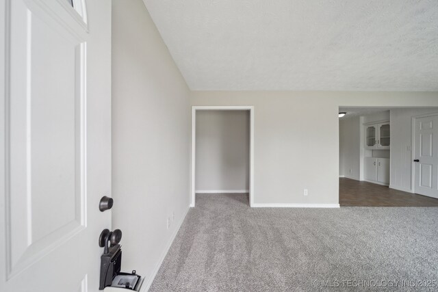 128 Suburban Ln, Inola, OK 74036 - carpeted spare room featuring baseboards and a textured ceiling