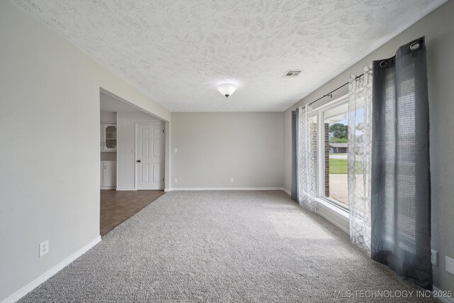 128 Suburban Ln, Inola, OK 74036 - unfurnished room with carpet flooring, baseboards, and a textured ceiling
