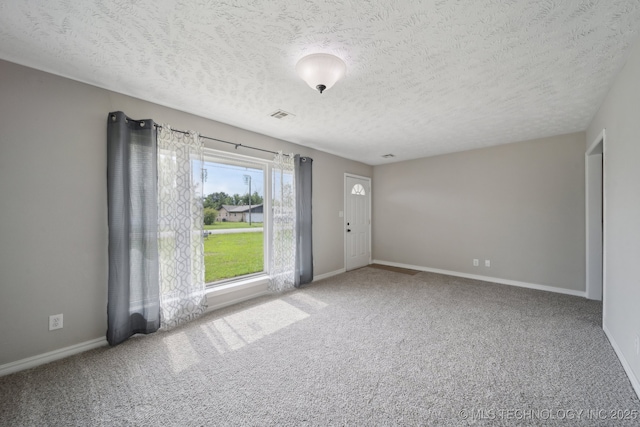 128 Suburban Ln, Inola, OK 74036 - carpeted spare room featuring baseboards and a textured ceiling