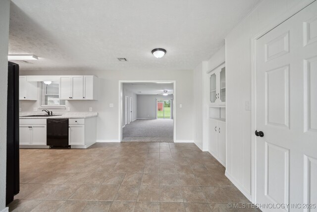 128 Suburban Ln, Inola, OK 74036 - kitchen with dishwasher, white cabinets, light countertops, baseboards, and built in features