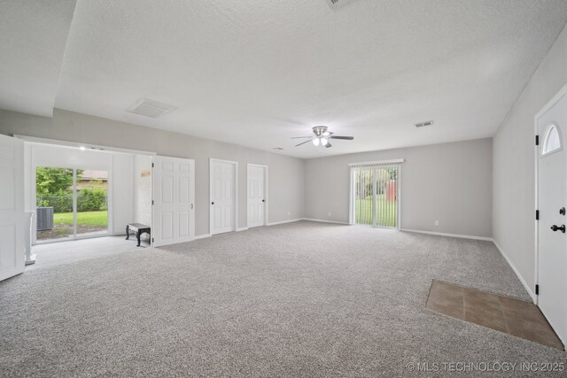 128 Suburban Ln, Inola, OK 74036 - carpeted spare room featuring ceiling fan, a textured ceiling, and baseboards