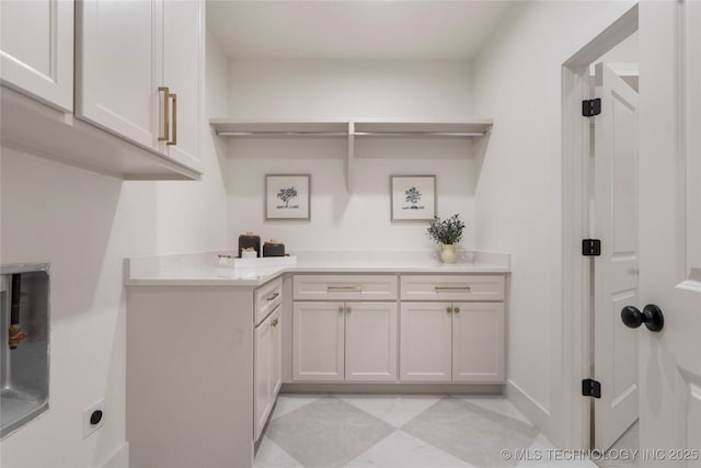 2338 E 134th St S, Bixby, OK 74008 - laundry area with electric dryer hookup, cabinet space, and light tile patterned floors