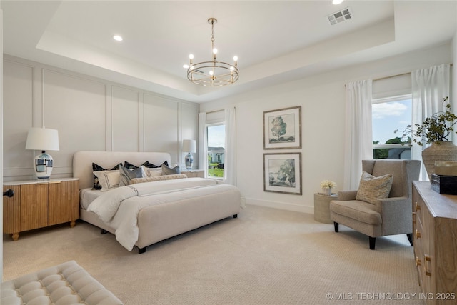 2338 E 134th St S, Bixby, OK 74008 - bedroom featuring a tray ceiling, a chandelier, light carpet, multiple windows, and a decorative wall