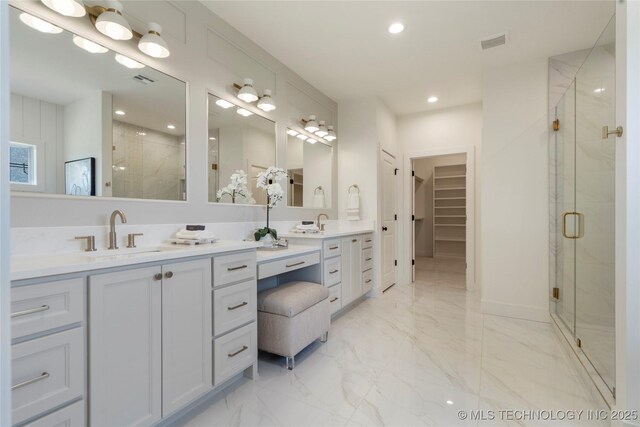 2338 E 134th St S, Bixby, OK 74008 - bathroom featuring a marble finish shower, double vanity, marble finish floors, a spacious closet, and recessed lighting