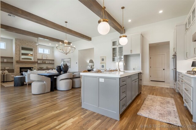 2338 E 134th St S, Bixby, OK 74008 - kitchen with gray cabinetry, white cabinets, light countertops, open floor plan, and beamed ceiling