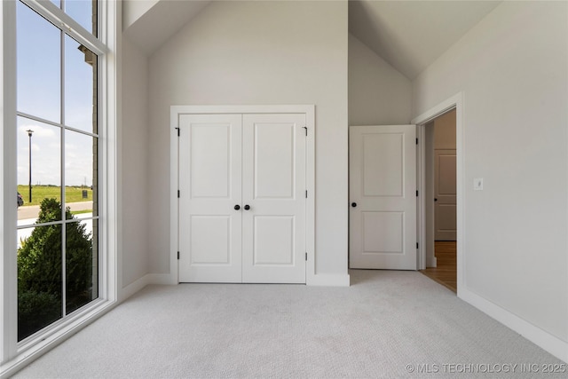 2338 E 134th St S, Bixby, OK 74008 - unfurnished bedroom featuring light colored carpet, high vaulted ceiling, and a closet