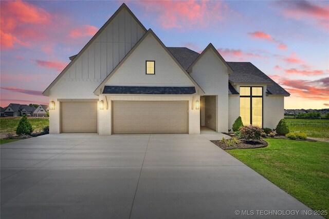 2338 E 134th St S, Bixby, OK 74008 - view of front facade with board and batten siding, brick siding, a shingled roof, and an attached garage