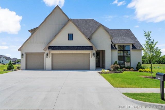 2338 E 134th St S, Bixby, OK 74008 - view of front of house featuring board and batten siding, brick siding, a front yard, roof with shingles, and driveway