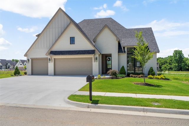 2338 E 134th St S, Bixby, OK 74008 - view of front facade featuring board and batten siding, a front yard, roof with shingles, concrete driveway, and brick siding