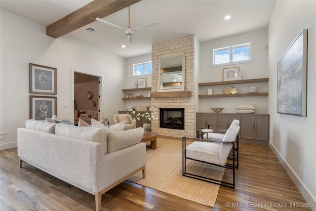 2338 E 134th St S, Bixby, OK 74008 - living area with ceiling fan, wood finished floors, a fireplace, beam ceiling, and recessed lighting