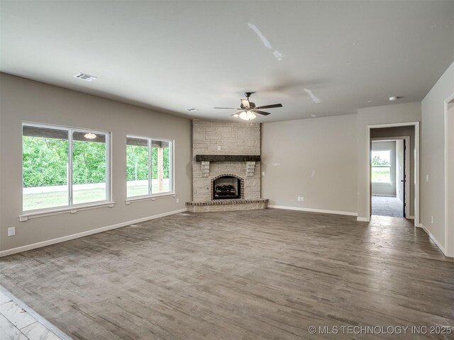 13155 S 105th E Ave, Bixby, OK 74008 - unfurnished living room featuring ceiling fan, wood finished floors, baseboards, and a large fireplace