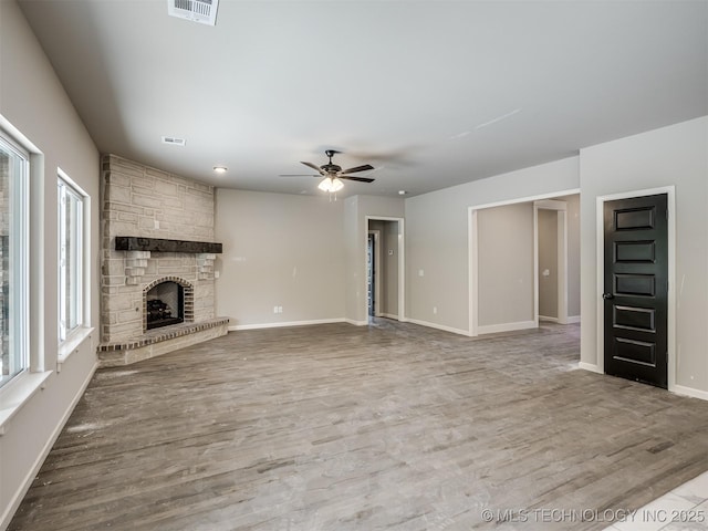 13155 S 105th E Ave, Bixby, OK 74008 - unfurnished living room featuring a ceiling fan, a fireplace, wood finished floors, and baseboards