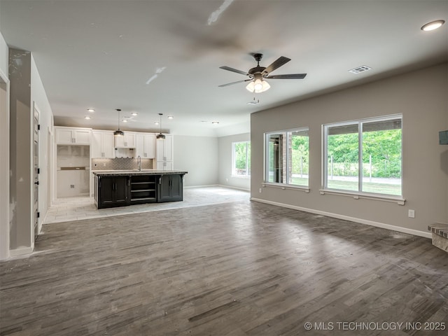 13155 S 105th E Ave, Bixby, OK 74008 - unfurnished living room featuring a sink, a ceiling fan, light wood finished floors, baseboards, and recessed lighting