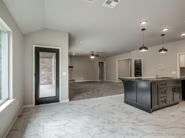 13155 S 105th E Ave, Bixby, OK 74008 - kitchen with a sink, light marble finish floors, baseboards, ceiling fan, and dark stone counters