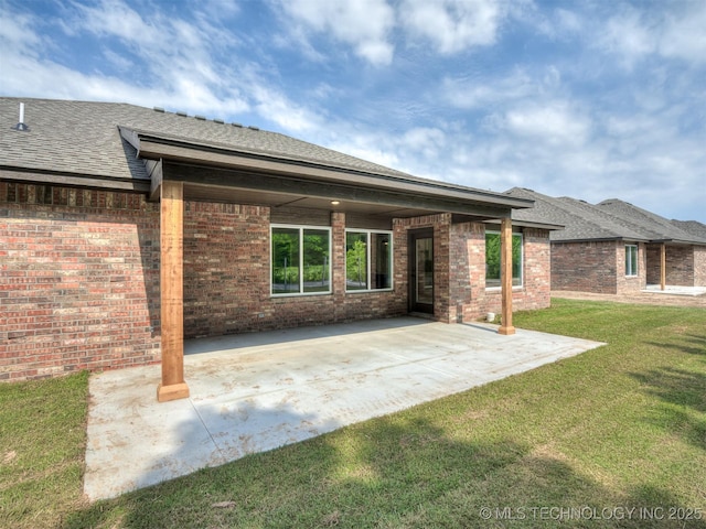 13155 S 105th E Ave, Bixby, OK 74008 - back of house with a lawn, a patio area, brick siding, and a shingled roof