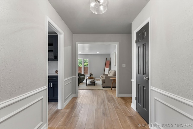 7532 E 55th Pl, Tulsa, OK 74145 - corridor featuring light wood finished floors and wainscoting