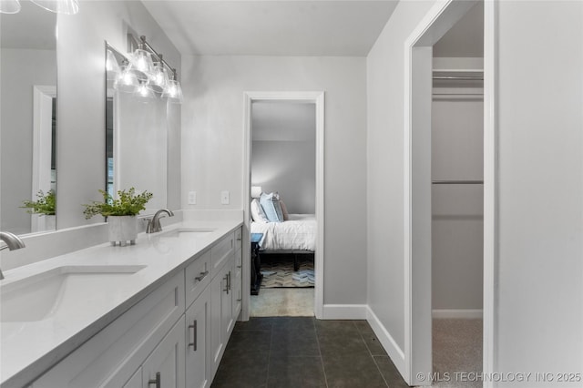 7532 E 55th Pl, Tulsa, OK 74145 - full bathroom featuring double vanity, connected bathroom, a spacious closet, baseboards, and tile patterned floors