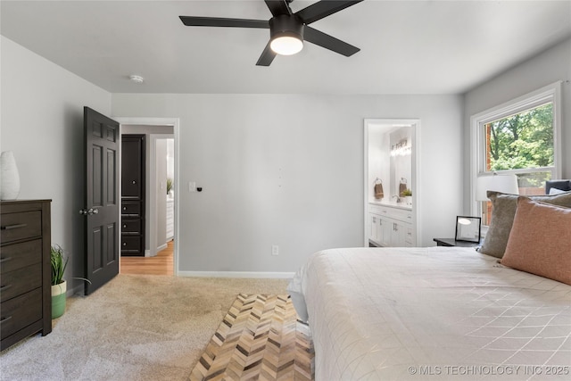 7532 E 55th Pl, Tulsa, OK 74145 - bedroom with light carpet, baseboards, ensuite bathroom, and ceiling fan