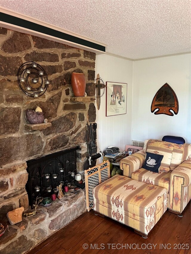 95398 S 4556, Vian, OK 74962 - living room with wood-type flooring, a textured ceiling, and a fireplace