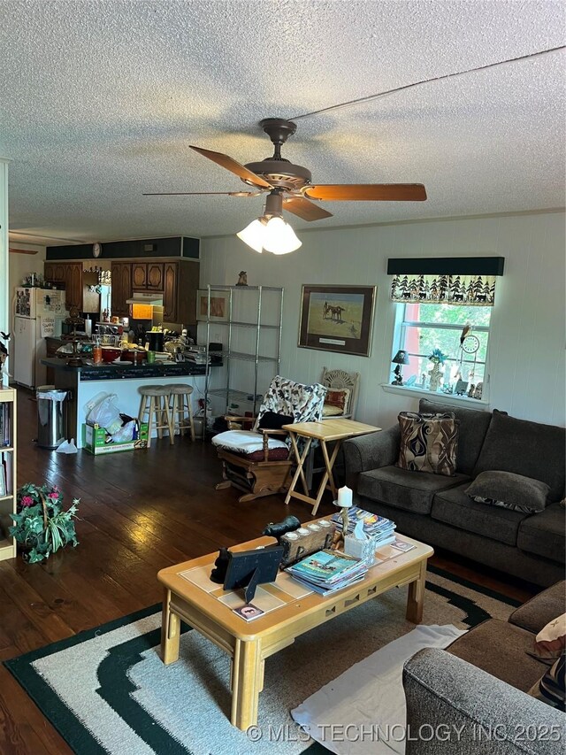 95398 S 4556, Vian, OK 74962 - living room featuring dark wood-style floors, a ceiling fan, and a textured ceiling