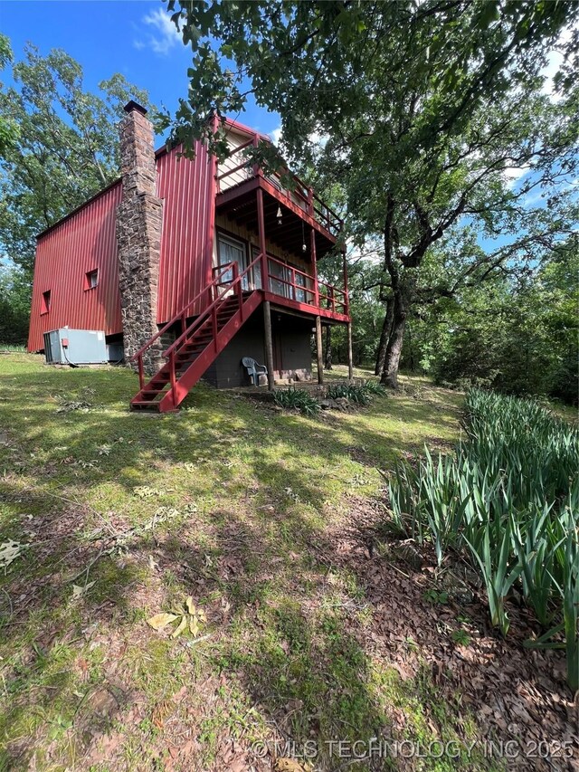 95398 S 4556, Vian, OK 74962 - back of house with a chimney, stairway, a wooden deck, and a yard