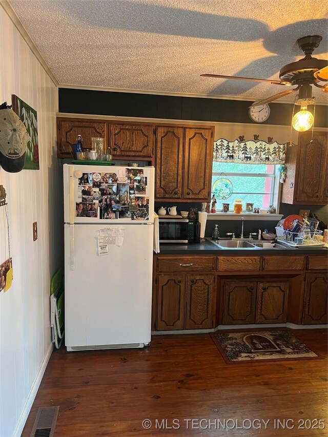95398 S 4556, Vian, OK 74962 - kitchen featuring freestanding refrigerator, a textured ceiling, dark countertops, ornamental molding, and a ceiling fan