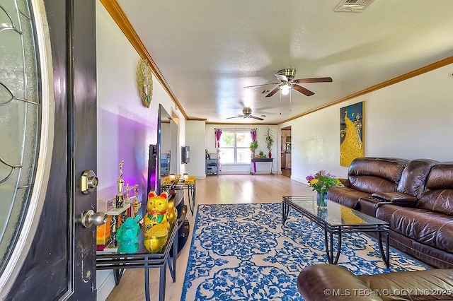 7008 S Hwy 28, Chelsea, OK 74016 - living room with ornamental molding, ceiling fan, wood finished floors, and baseboards
