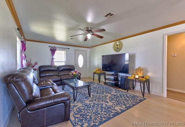 7008 S Hwy 28, Chelsea, OK 74016 - living area with wood finished floors, a ceiling fan, ornamental molding, baseboards, and a textured ceiling