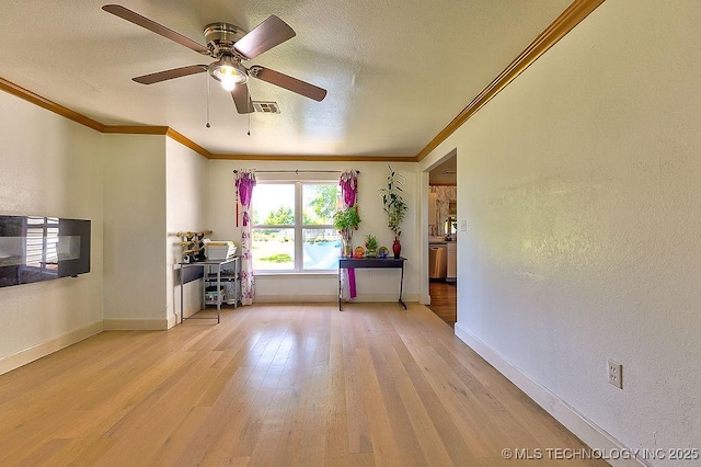 7008 S Hwy 28, Chelsea, OK 74016 - unfurnished room with ornamental molding, light wood-style floors, a ceiling fan, baseboards, and a textured wall